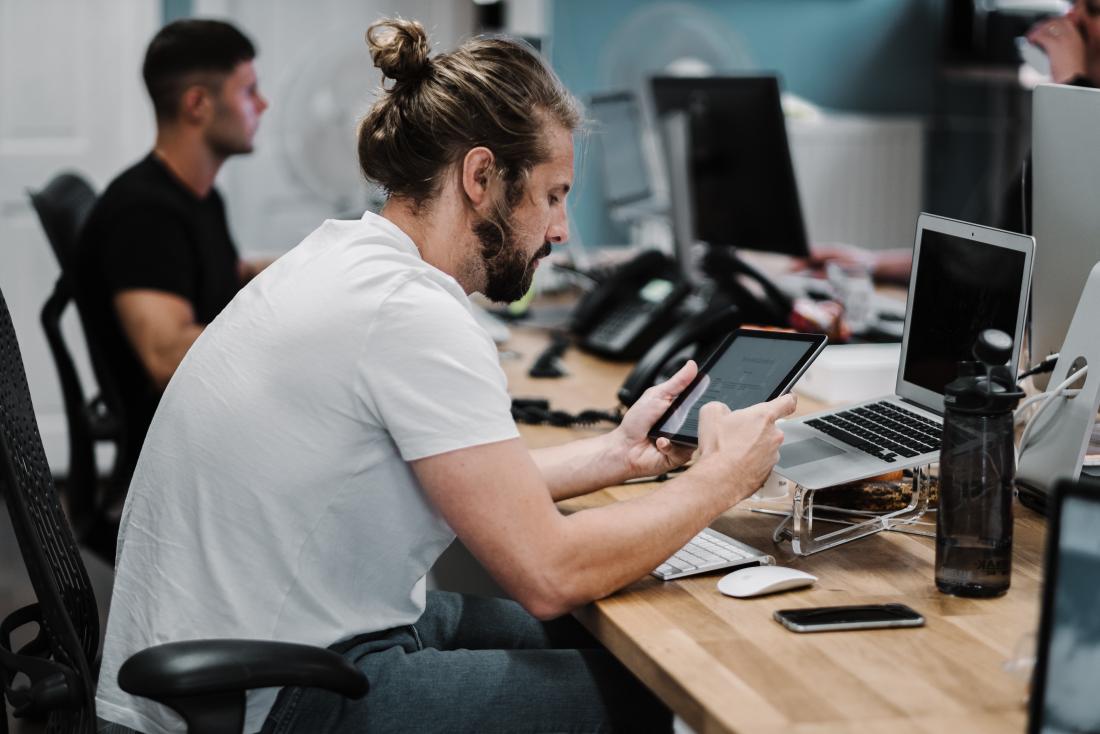 person using a tablet at their desk