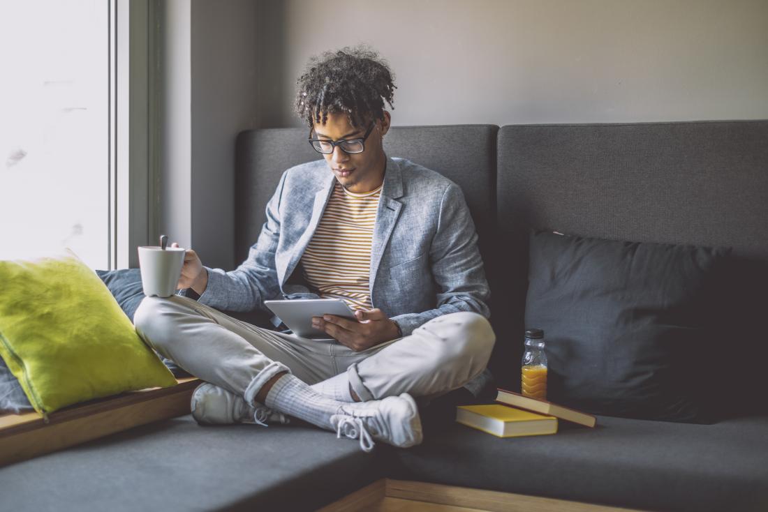 a man relaxing with a coffee and iPad