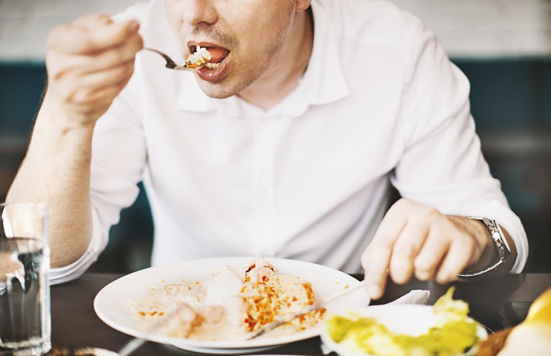 a man eating lunch at a table.