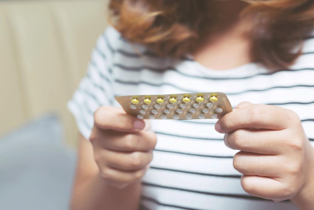 a woman about to take birth control pills for a Period that won't stop