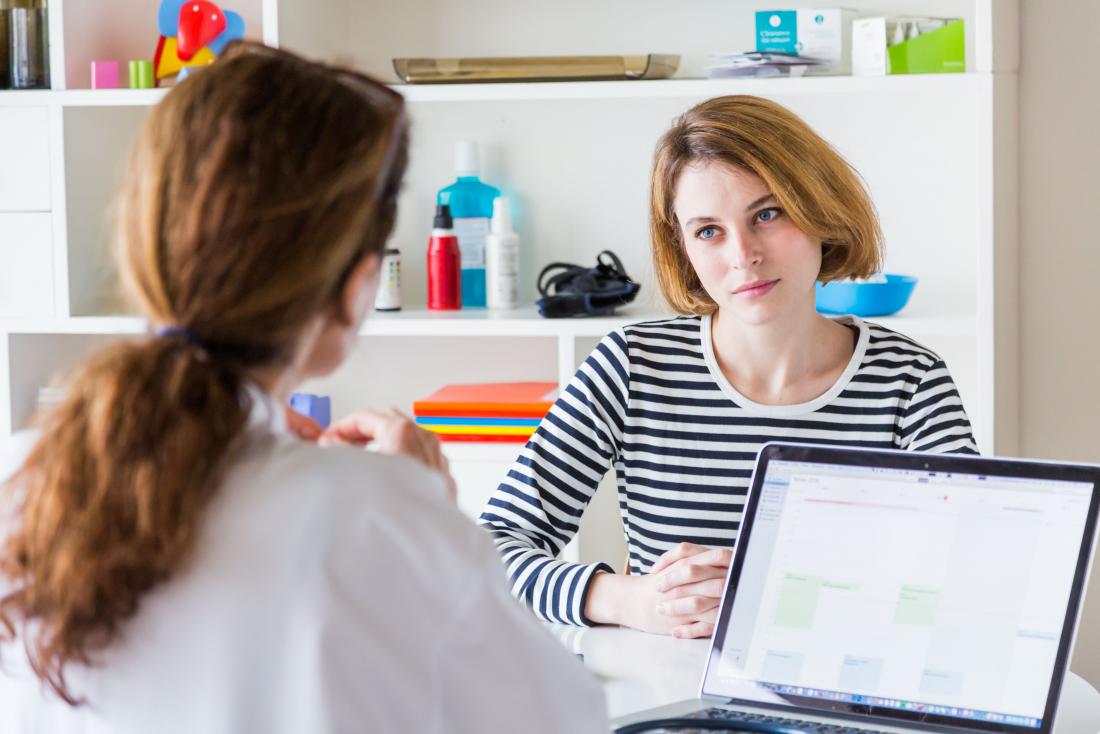 patient with end stage liver disease due to hepatitis c in doctor s office sitting across from gp