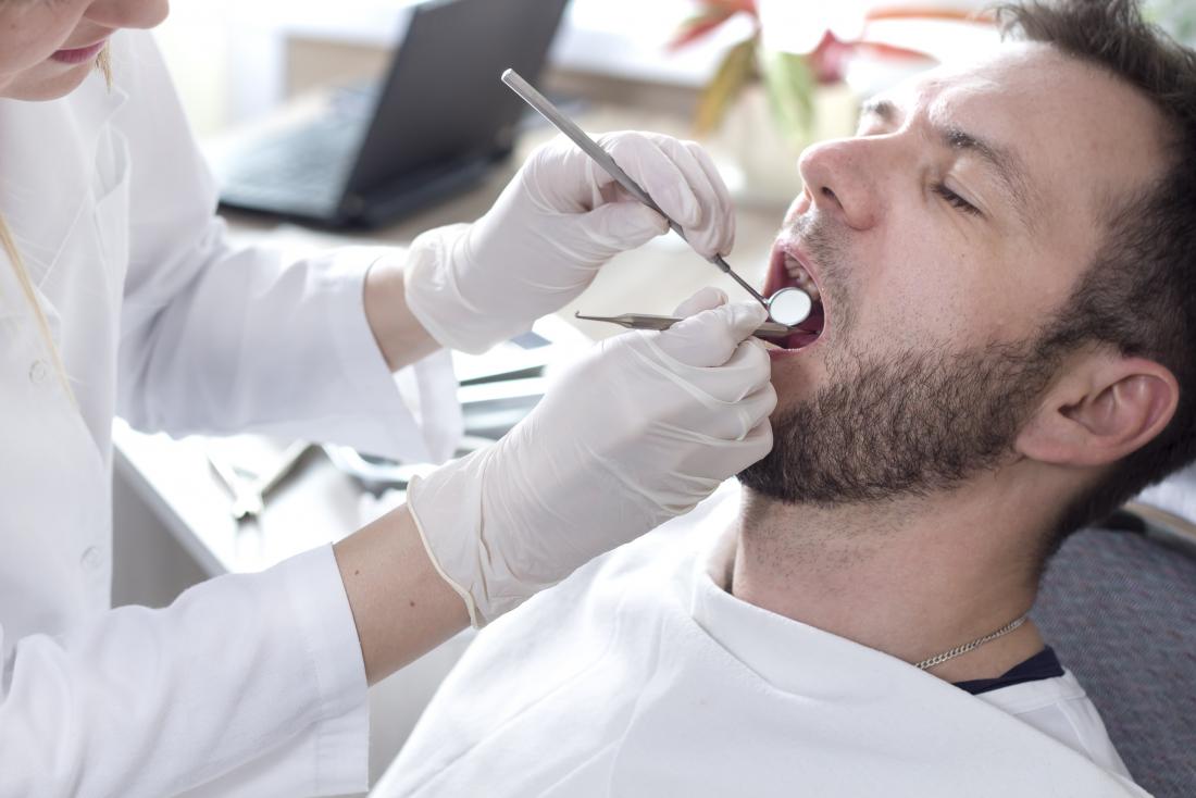 a man getting a dental inspection