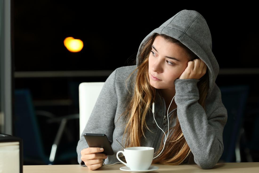 a woman drinking coffee even though it triggers her Anxiety