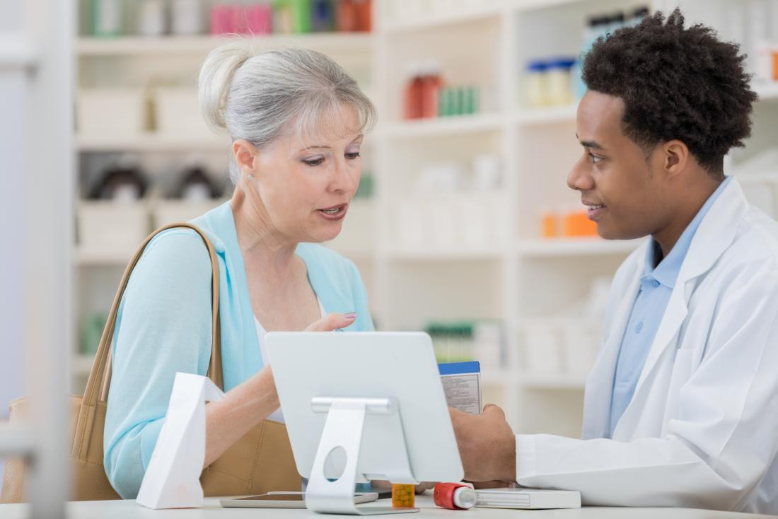 a woman picking up her prescription for glimepiride