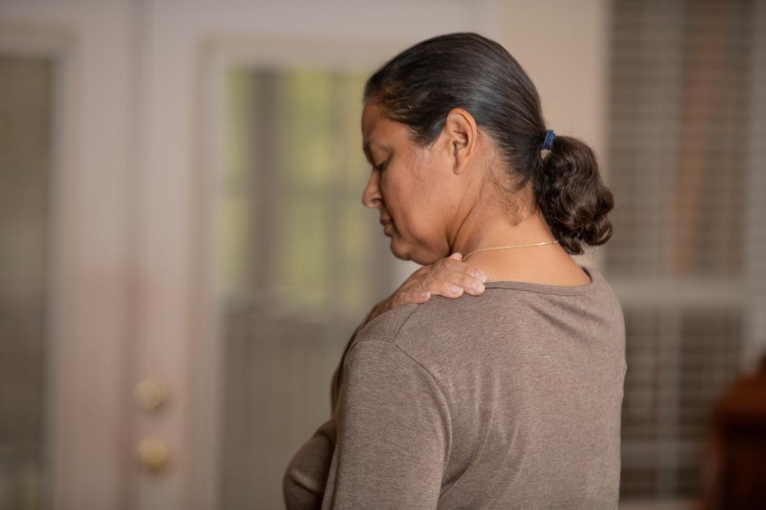 woman having pain in her shoulder