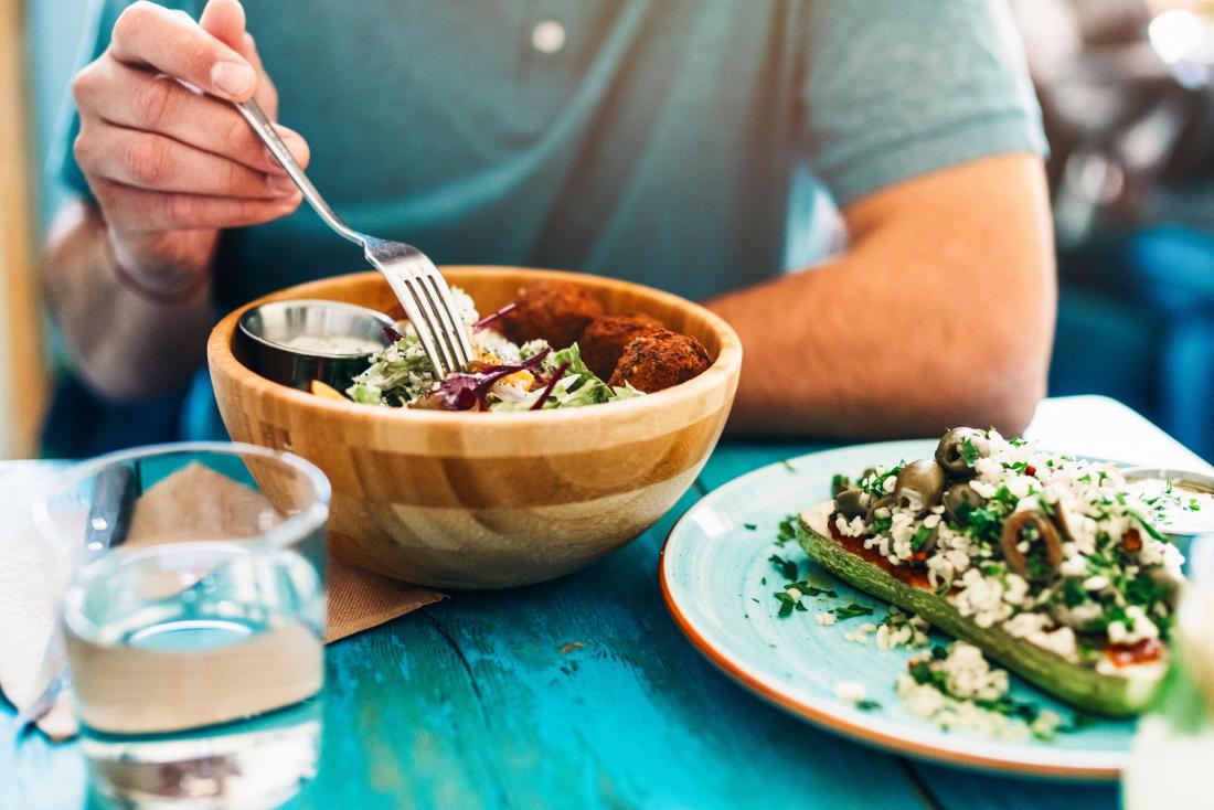 a man eating a meal as part of his Plant based diet