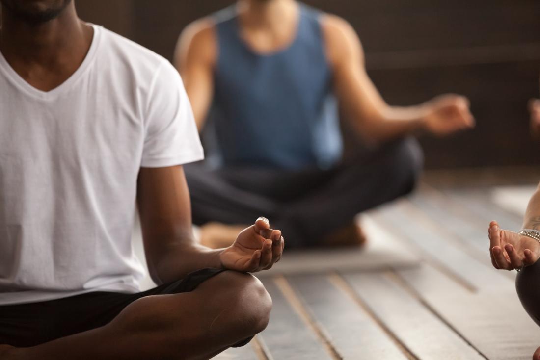 a group of men practicing mindfulness