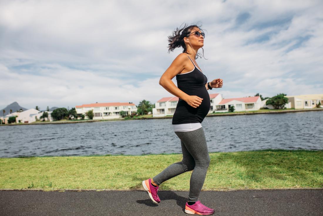 a pregnant woman out for a jog. 