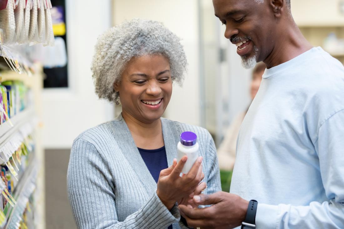 a couple looking in a shop at supplements for keto diets