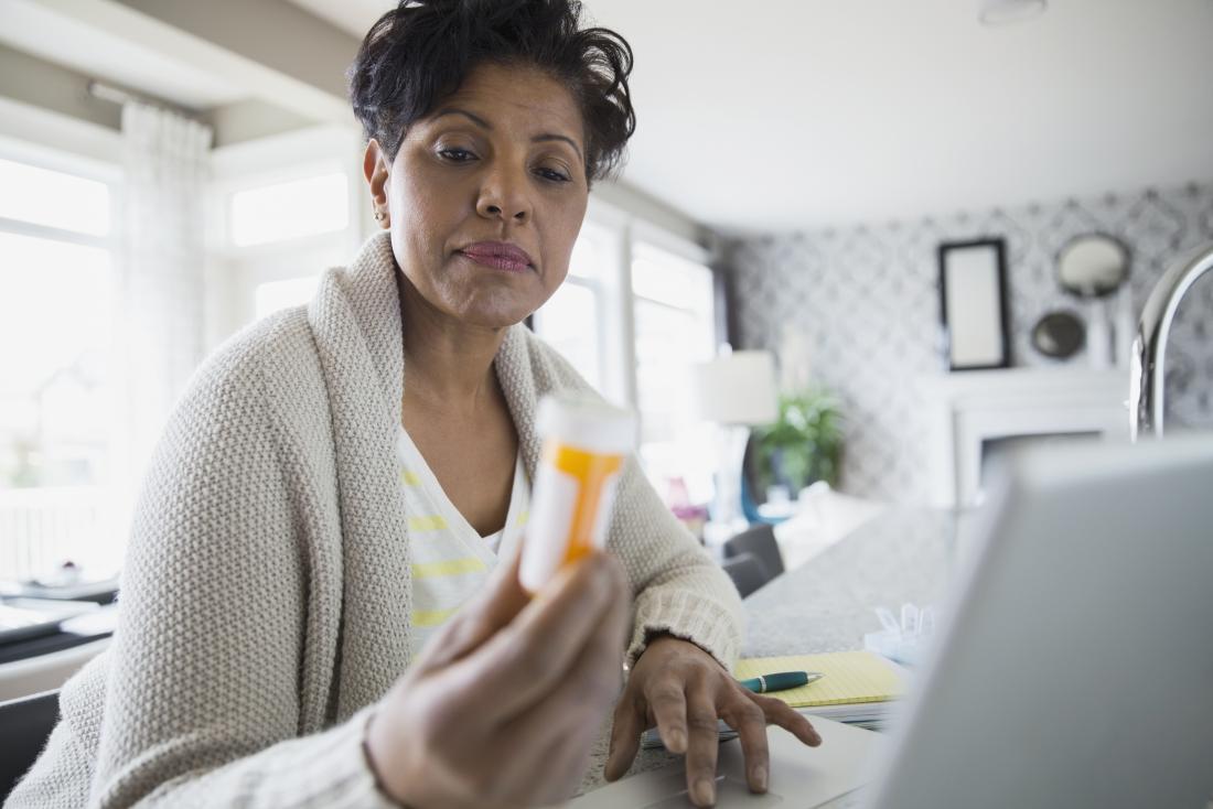 a lady holding a tube of pills wondering the pros and cons of concerta vs ritalin