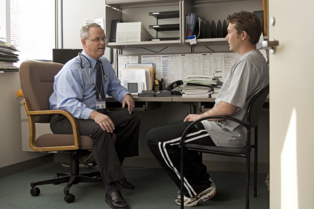 doctor and patient in office discussing adrenal cancer