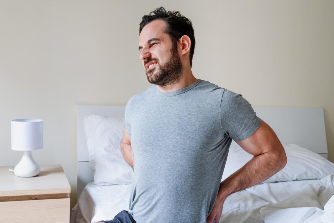 a man suffering from back ache or kidney stones