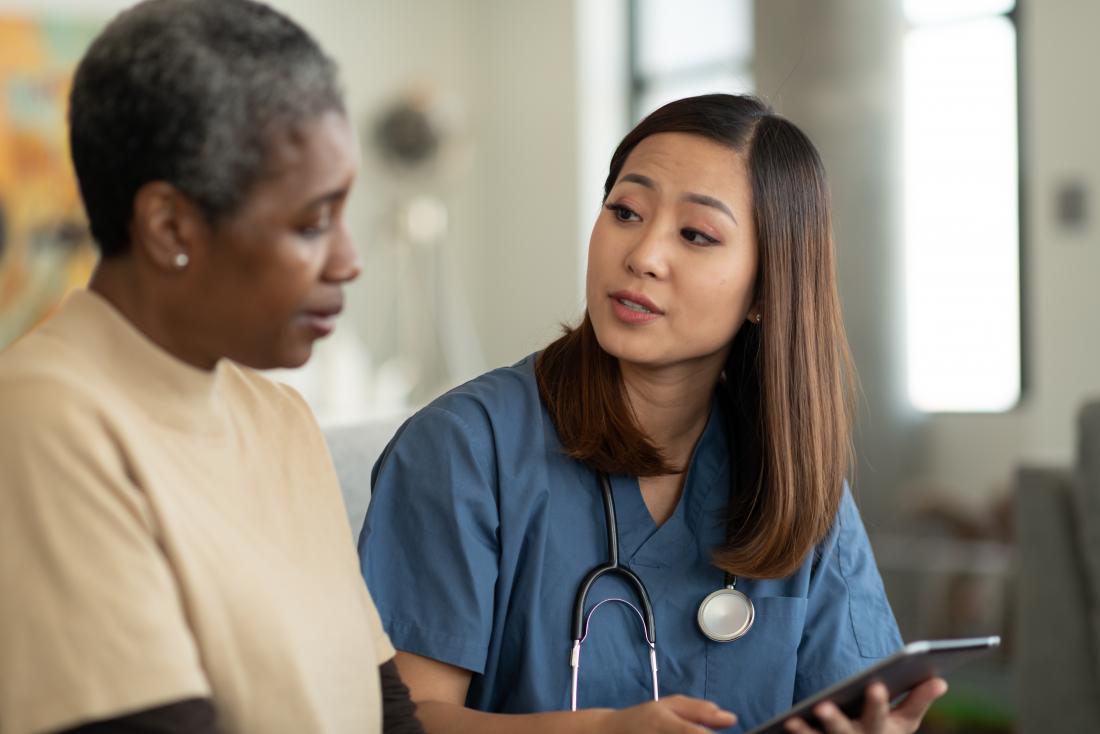 a doctor sharing results with an elderly patient<!--mce:protected %0A-->