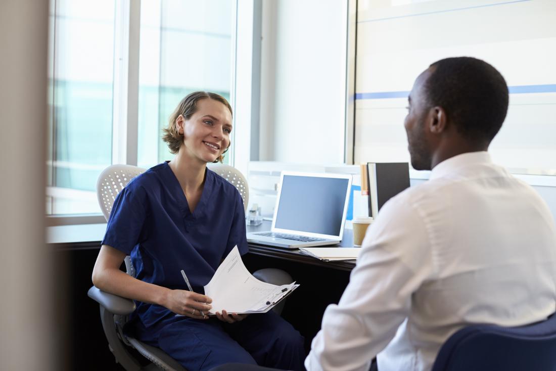 man talking to doctor in her office both smiling