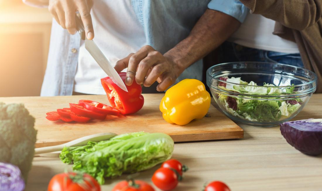 close up of man chopping vegetables