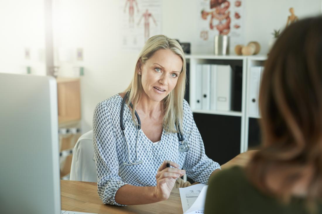 woman speaking to a female doctor