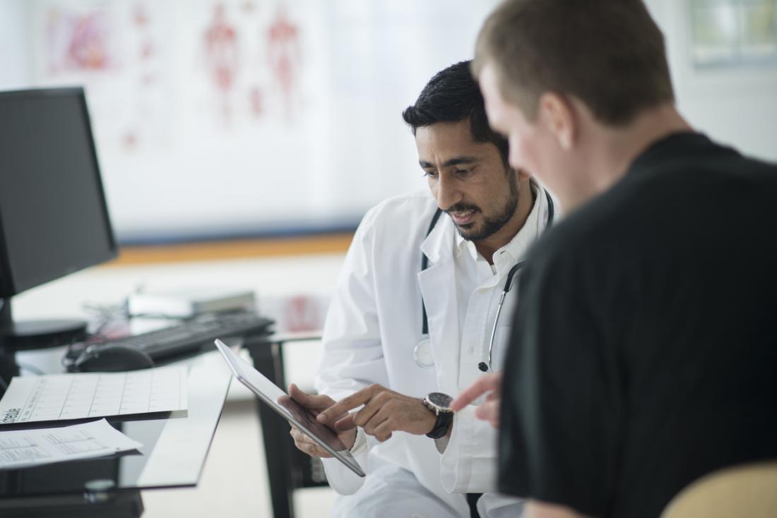doctor showing notes to patient