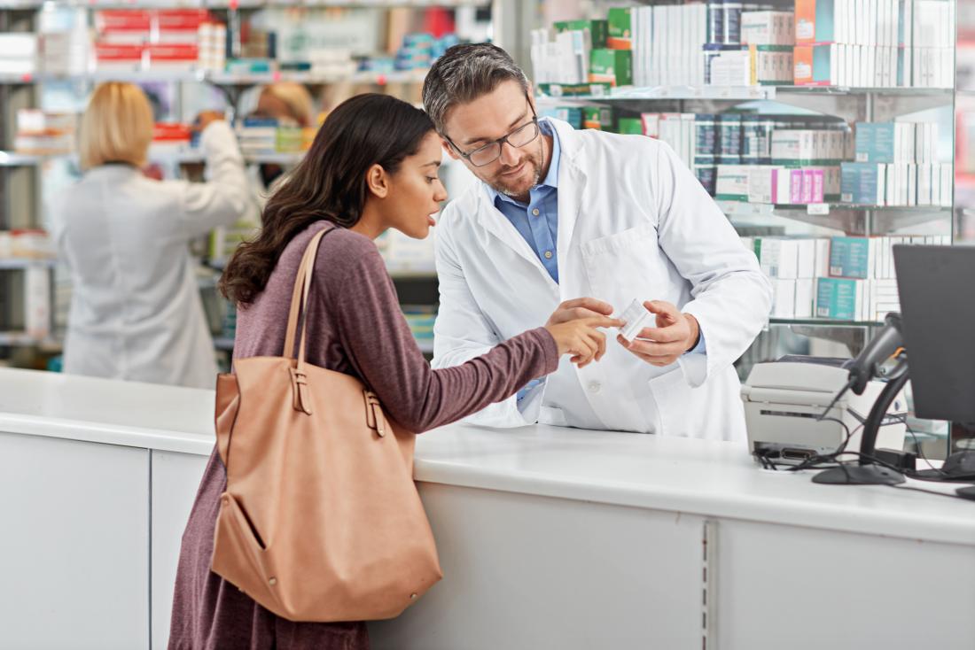 a woman picking up beta blockers at a pharmacy for her anxiety