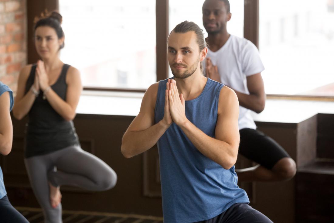 a man experiencing the benefits of group yoga