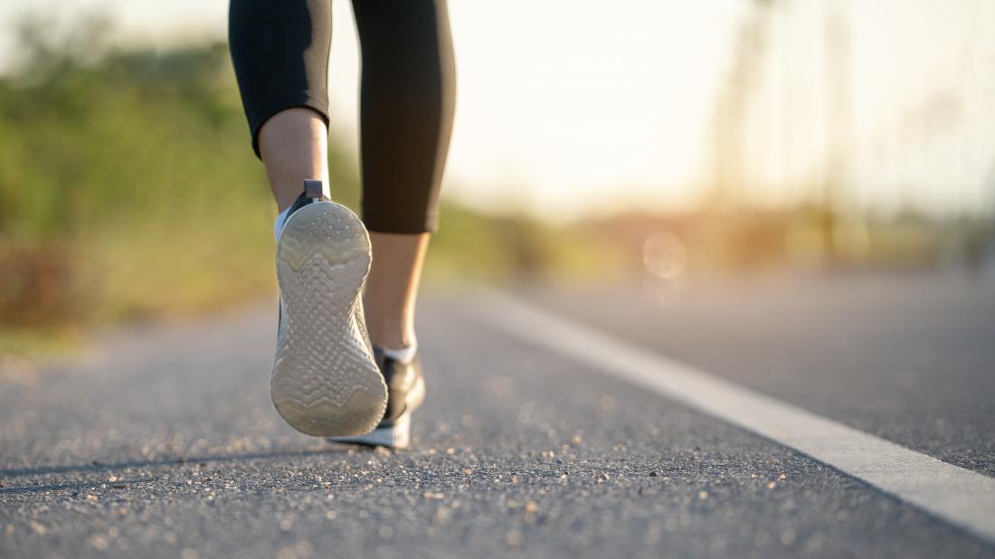 a low angle view of a persons legs who is running. 