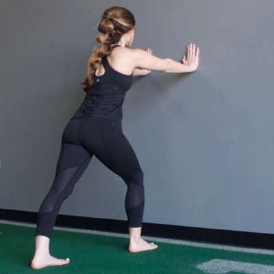 Standing wall stretch GIF