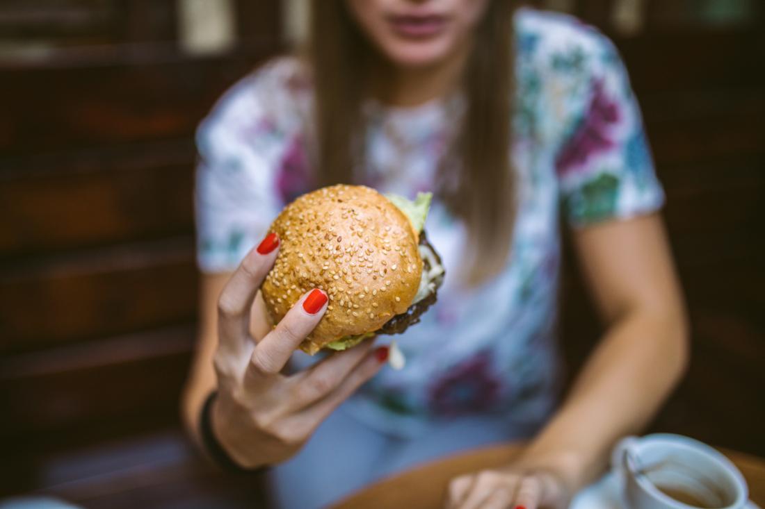 woman holding a hamburger
