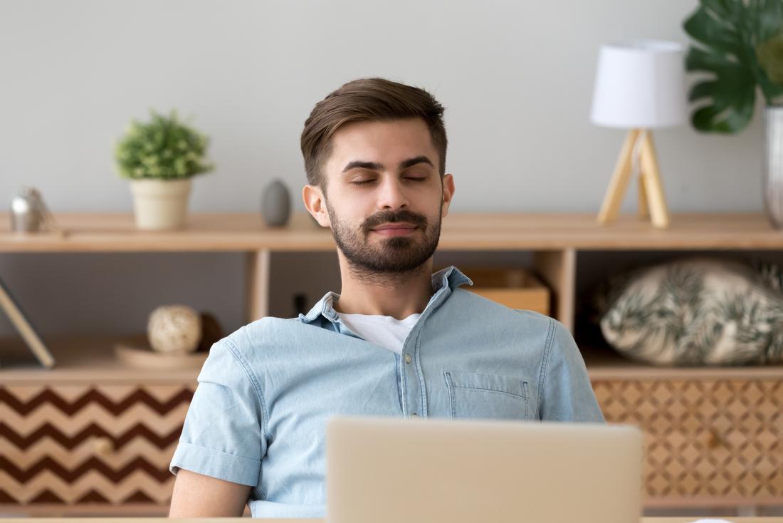 a man practicing deep breathing. 