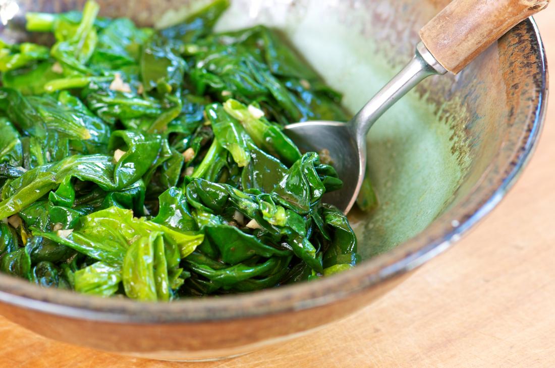 A Sauteed Spinach with Garlic in Pottery Bowl