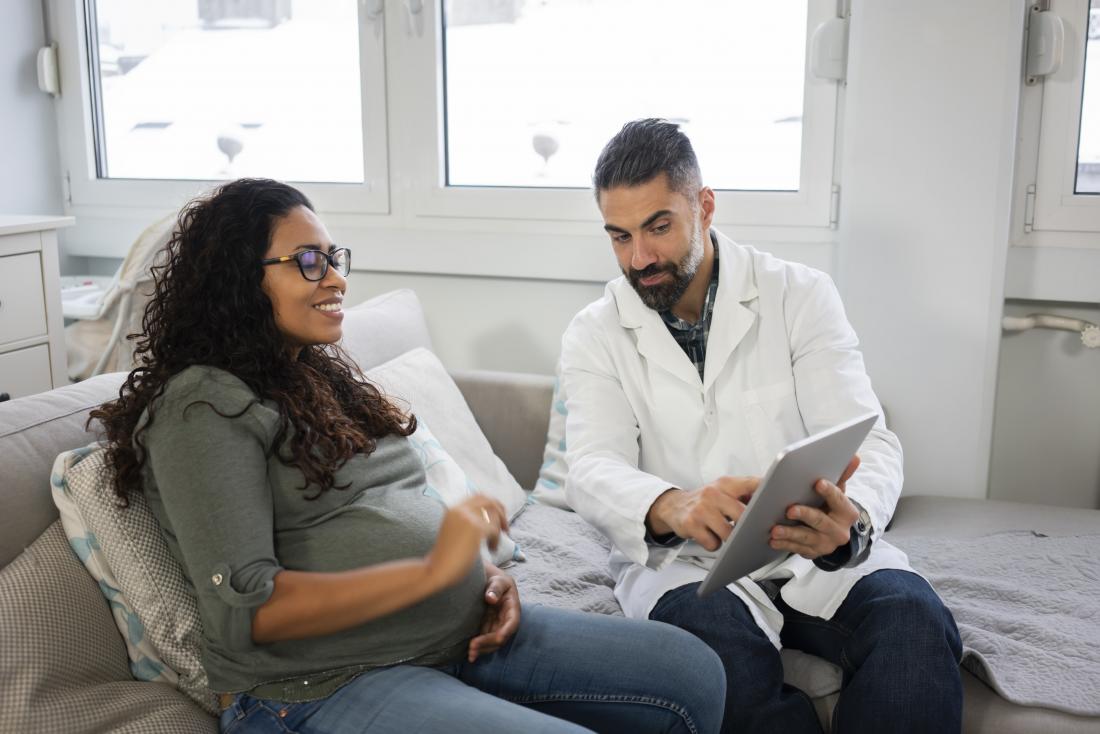 a pregnant woman having a final check with a doctor.