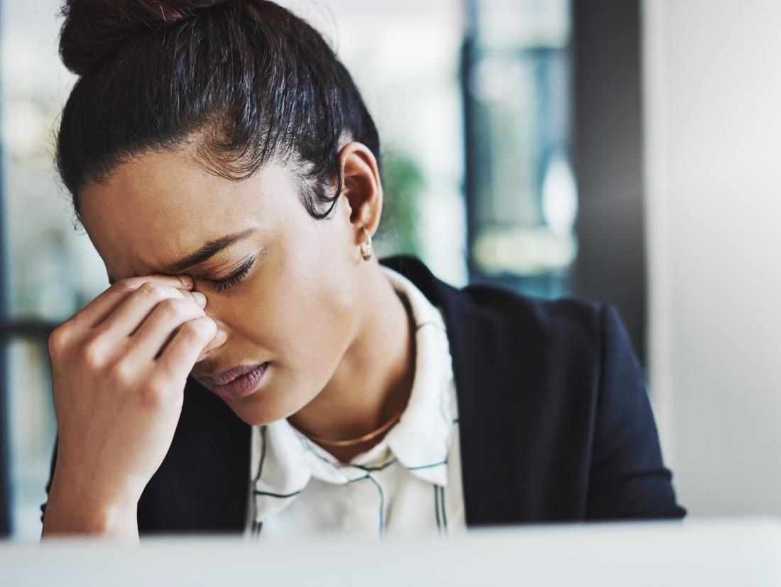 a woman experiencing a headache because of a period.