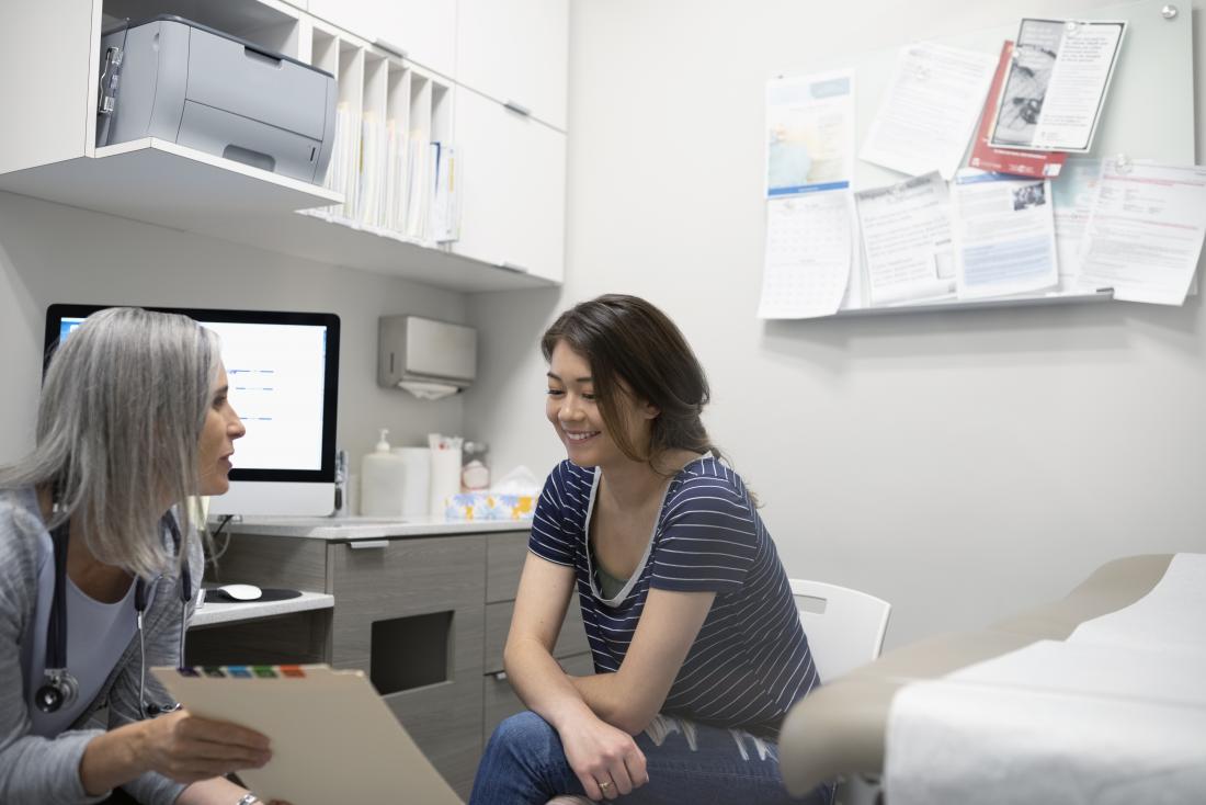 woman speaking to doctor about lumps on areola