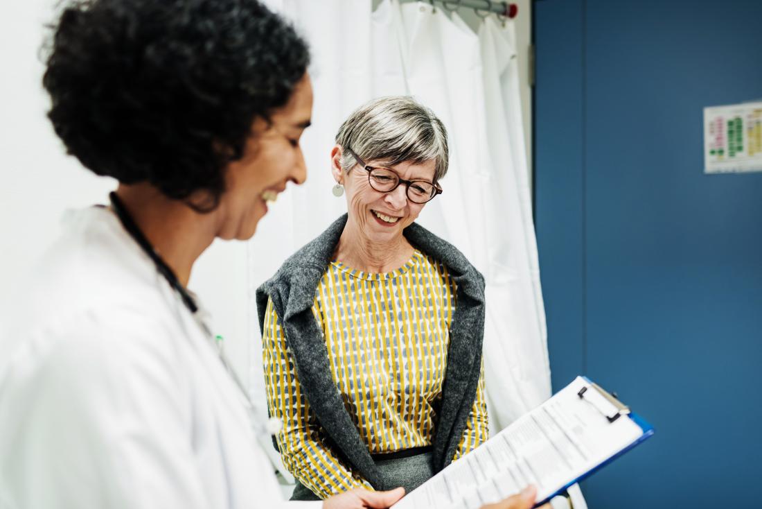 female patient with doctor discussing triple negative breast cancer recurrence and survival rates in office