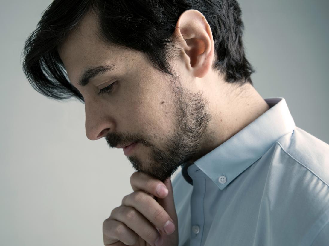 a man looking pensive about his penis sores. 