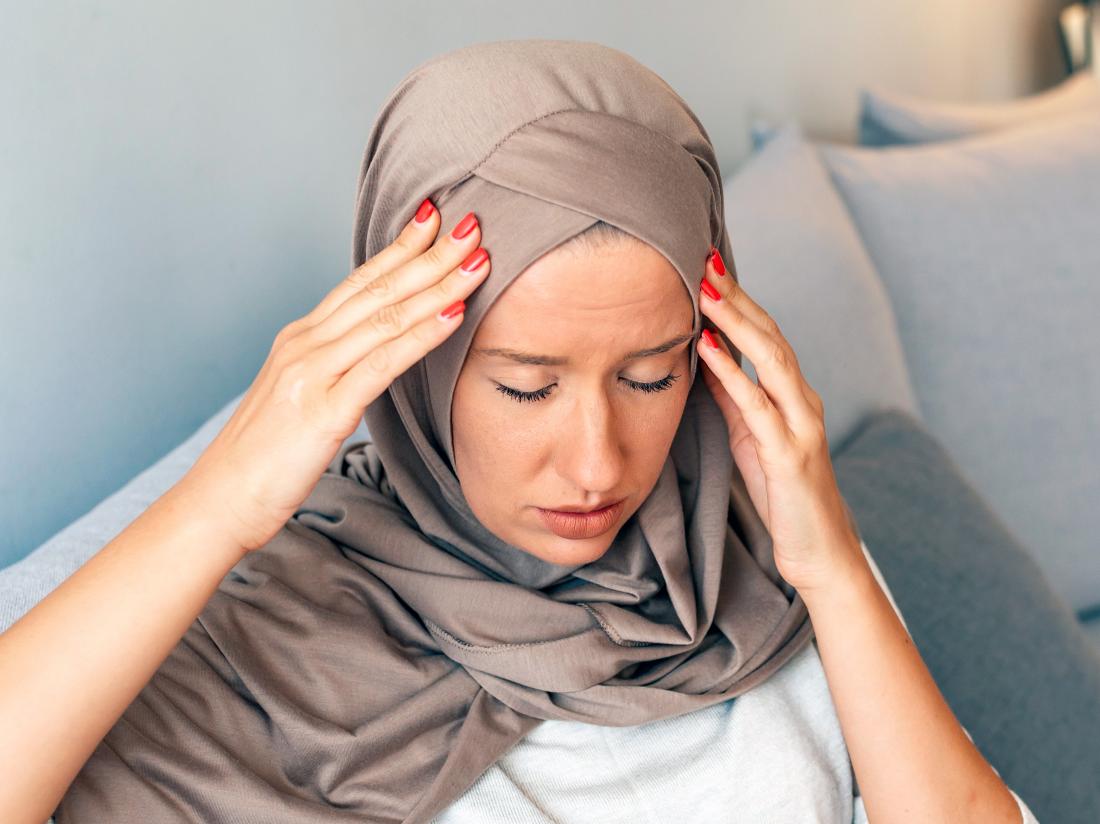a woman experiencing a headache with a Migraine aura