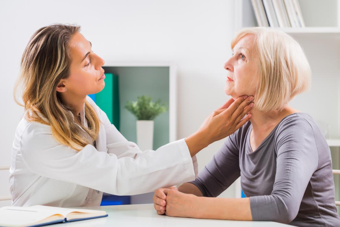 doctor checking person's glands