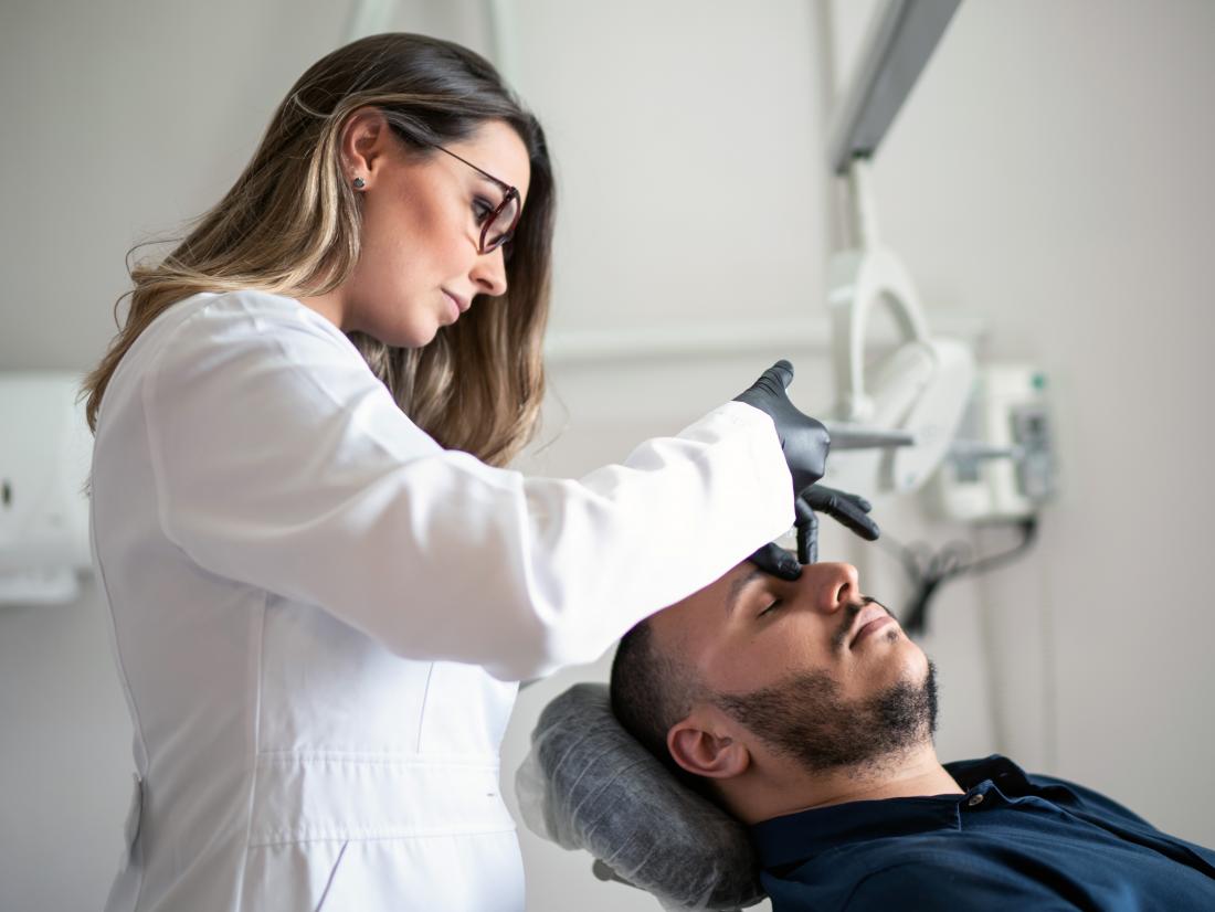 a man receiving botox to his face. 