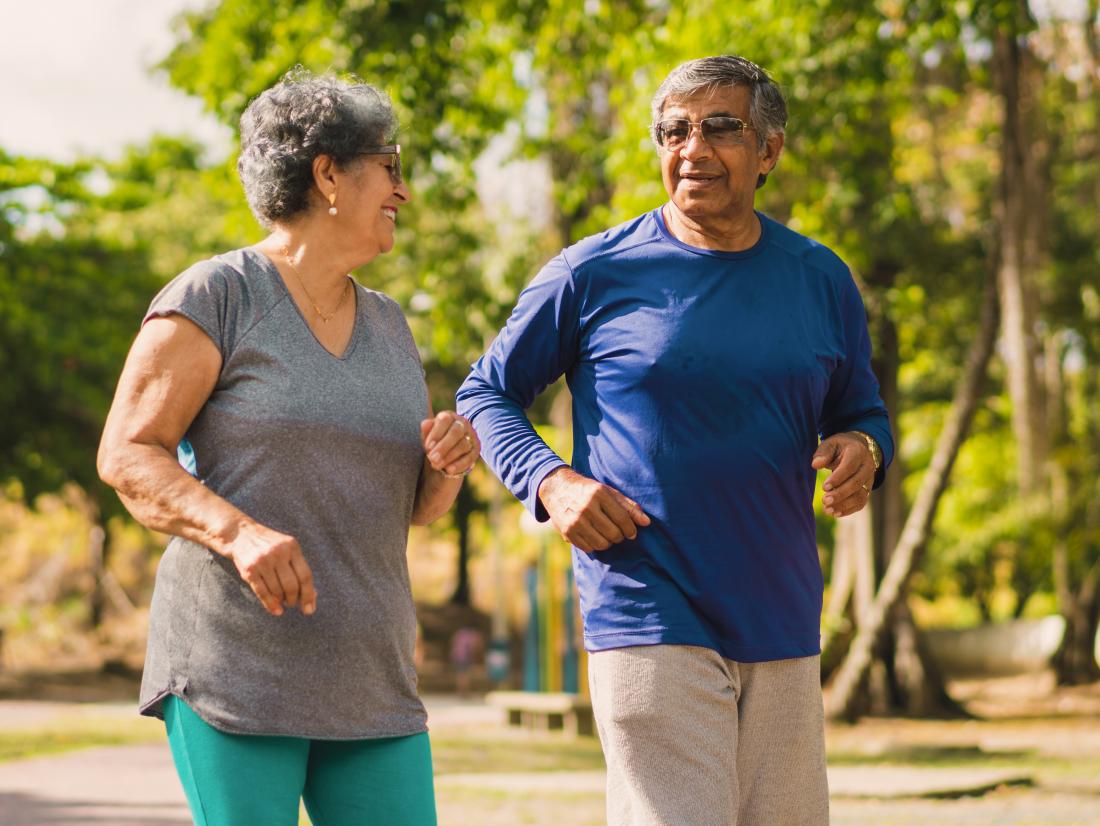 a senior couple having a gentle jog in the park. 