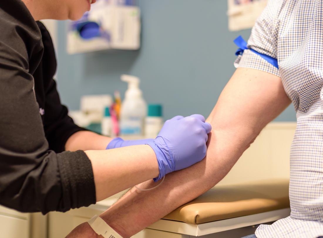 a doctor performing a blood test. 