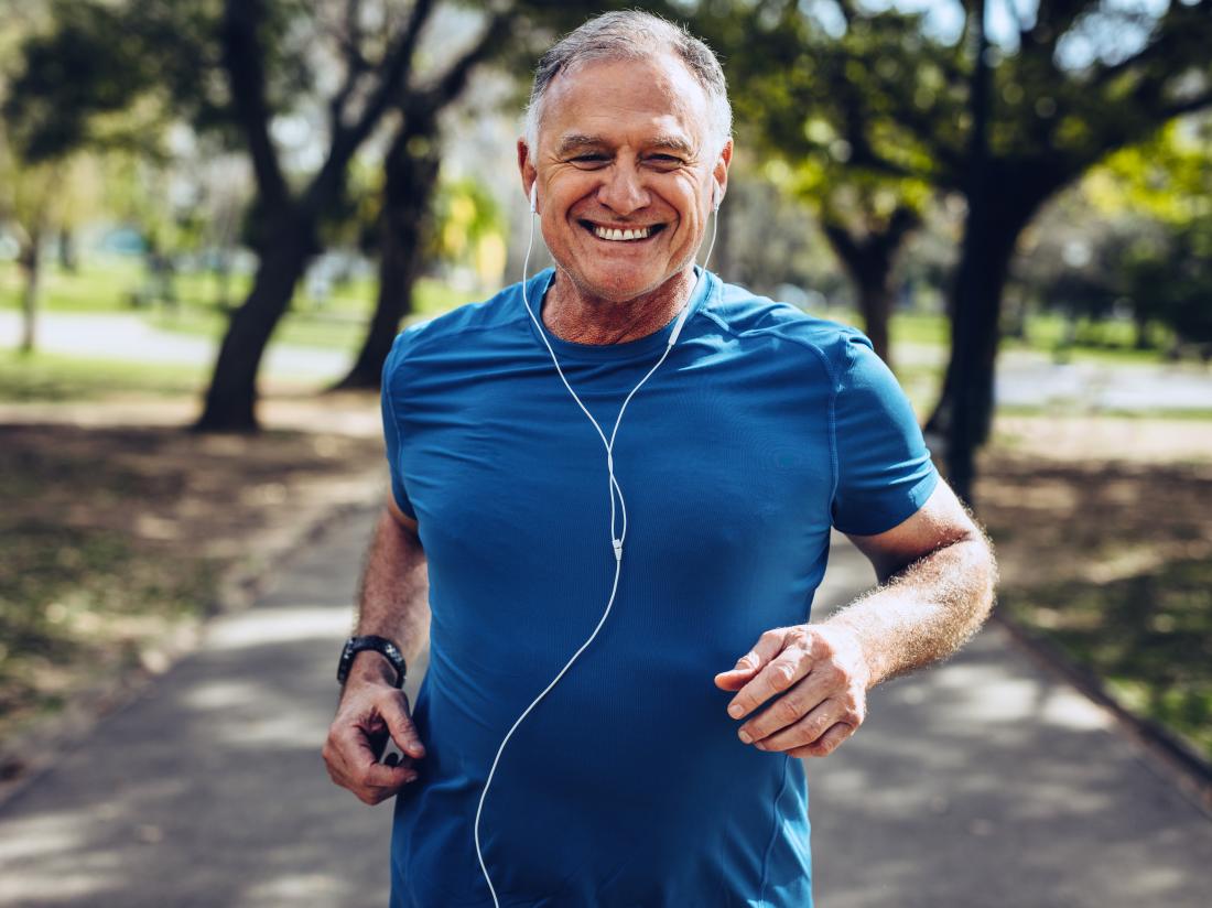 a older man having a jog and listening to music. 