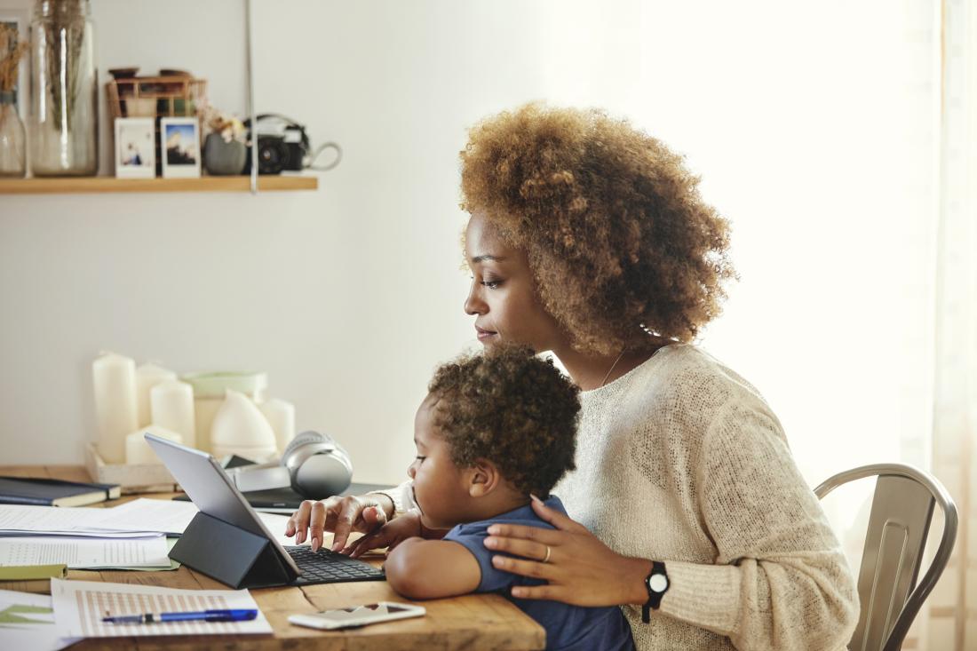 woman working with baby on her lap