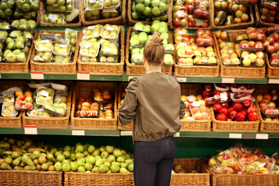 a woman shopping for fruit