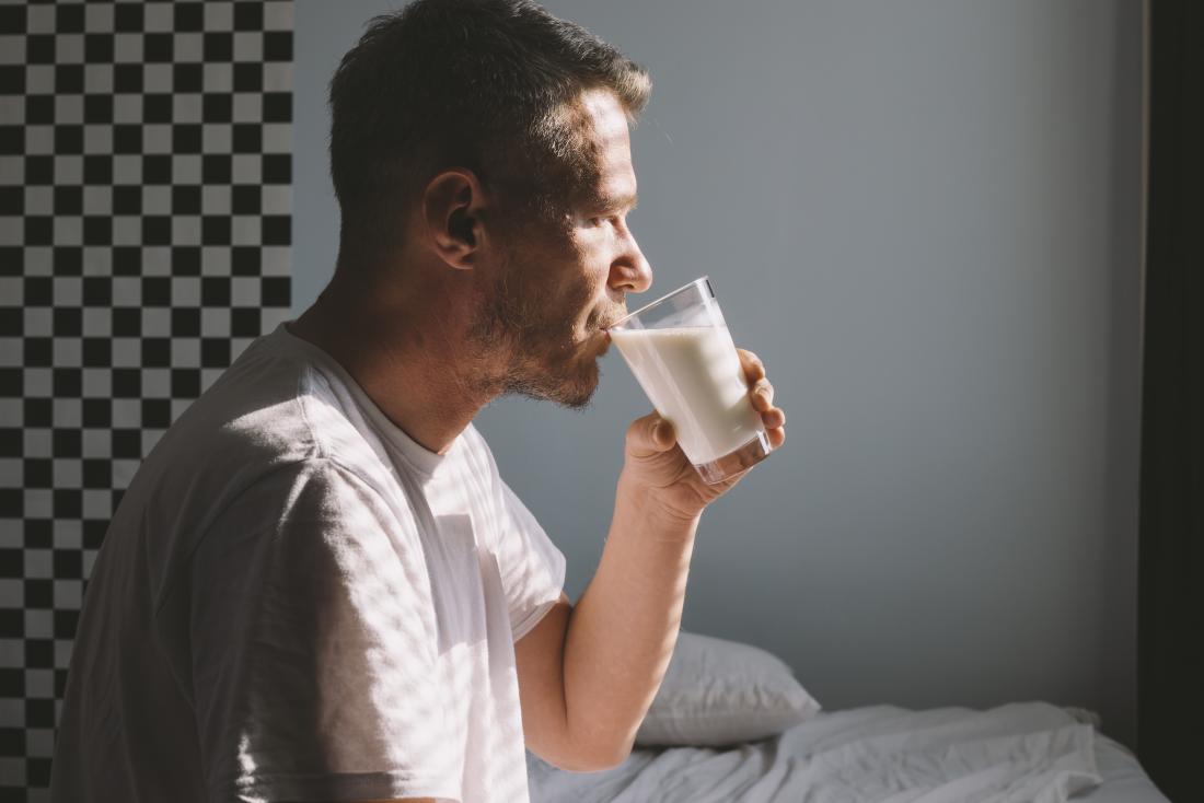 a man drinking a glass of milk