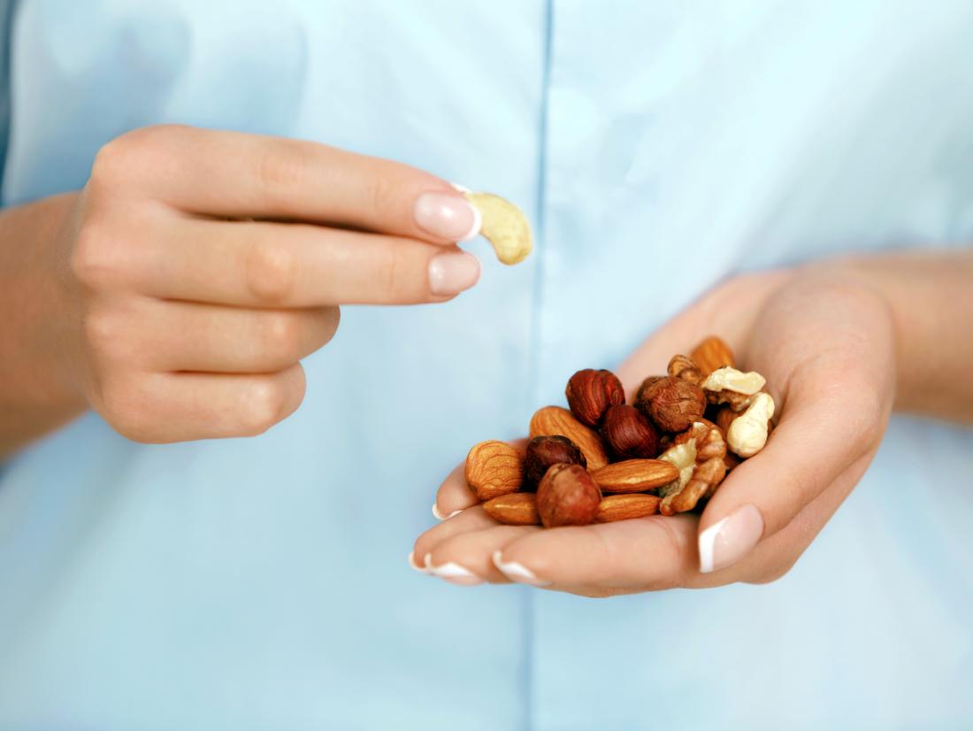 a person with nuts in there hand. 