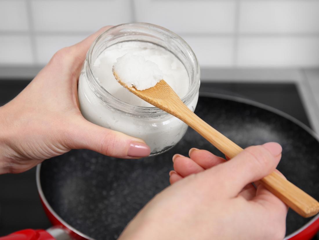 a woman cooking with coconut oil