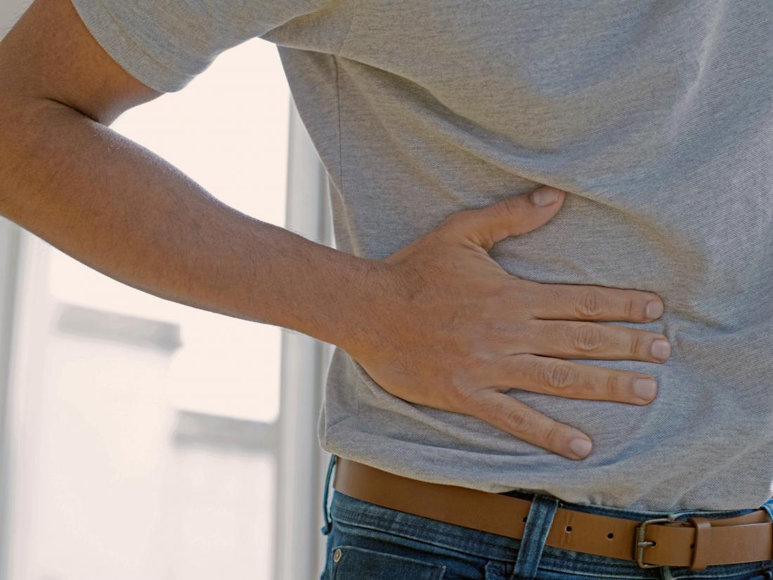 a man experiencing pain in his abdomen because of gallbladder polyps