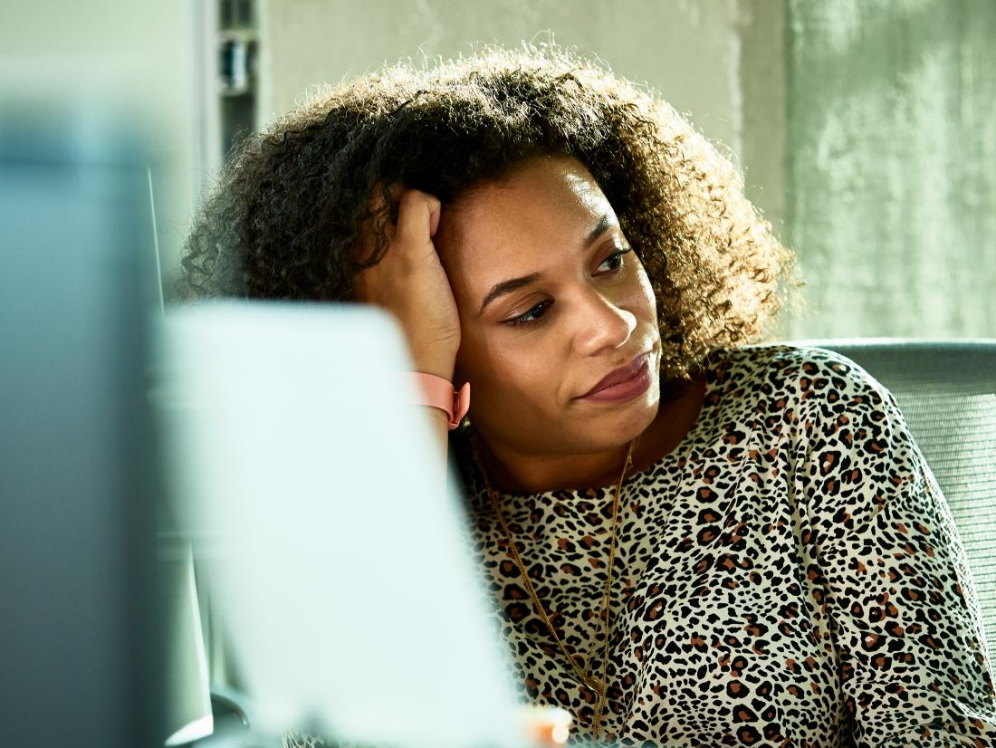 a woman looking frustrated at a work desk becasue of codeine withdrawal