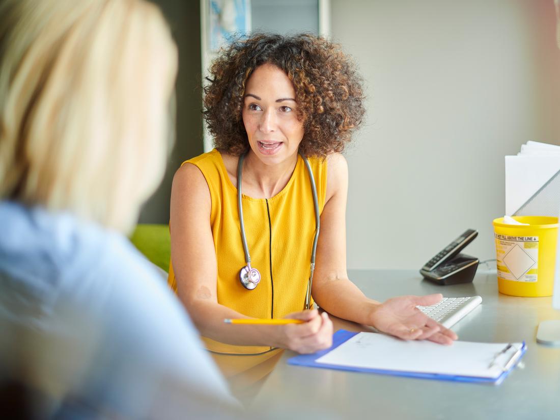 a doctor explaining to a patient what her gleason score is