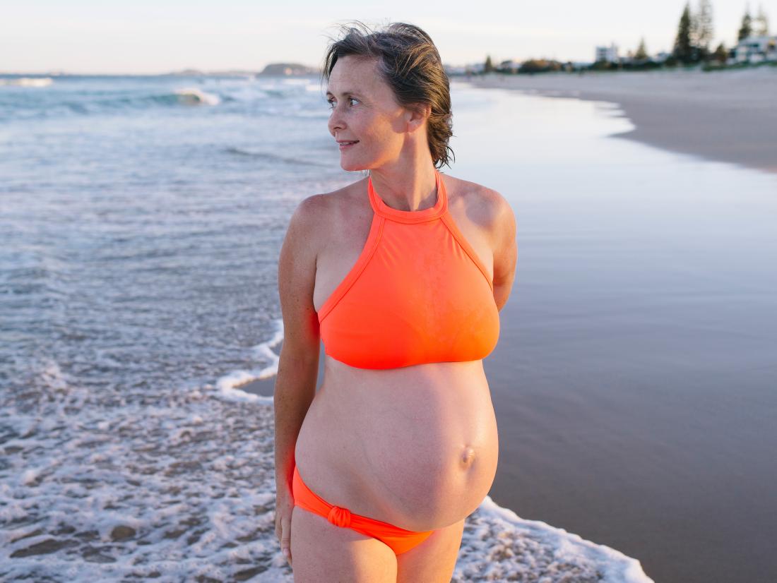 a mature pregnant woman on beach