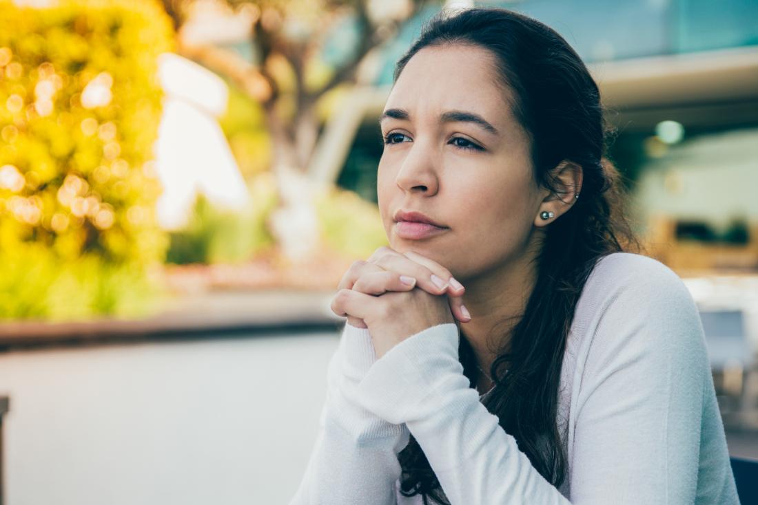 Pensive woman in the sun