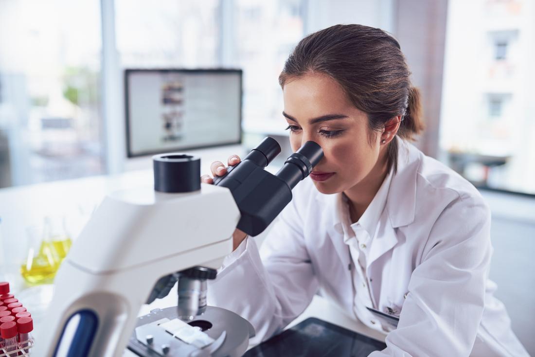 researcher using a microscope